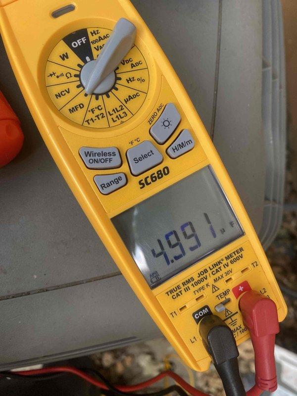 Responded to no cooling call where customer reported system blowing hot air with outdoor unit not operating. Upon arrival, performed electrical diagnostics on 10-year-old split system located in basement with condensing unit at ground level behind residence. Used digital multimeter to test compressor amperage draw and capacitor values, revealing electrical failure preventing outdoor unit operation. Diagnosed faulty run capacitor reading 499.1 MFD, significantly outside manufacturer specifications, causing compressor lockout and loss of cooling capacity. Advised customer of findings and provided repair options to restore system functionality.