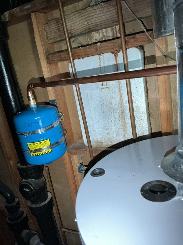 Completed installation of 40-gallon gas short water heater in accordance with permit #26plu-17223. Connected copper supply lines and gas piping to new unit, installed thermal expansion tank with proper mounting and pressure relief valve assembly, and applied required plumbing identification sticker per licensing requirements. All connections pressure-tested and verified for proper operation, with installation meeting local code requirements for residential gas water heater systems.
