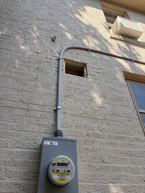 Completed comprehensive whole house electrical inspection of residential property. Evaluated exterior electrical service entrance, metering equipment, and weatherhead installation with conduit routing along exterior wall. Inspected main electrical panel containing older style screw-in fuse system with color-coded fuses (blue, yellow, and clear rings) and brass main disconnect fuses. Documented all findings with photographs for client records. System utilizes outdated fuse-based protection rather than modern circuit breakers, which was noted during inspection. All accessible electrical components, connections, and service equipment were visually examined for safety compliance and proper operation.