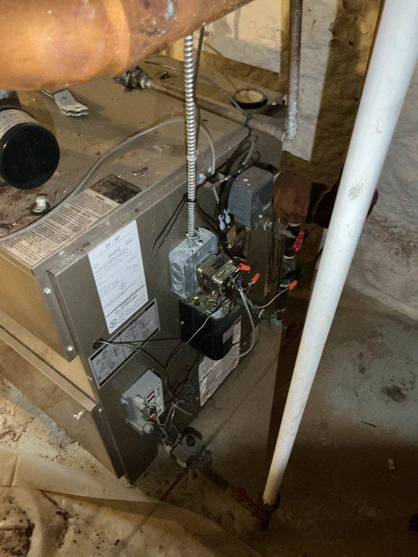 Responded to failed water heater inspection for permit #26-008124 regarding inadequate combustion air supply for fuel-burning appliances. Assessed basement mechanical room containing furnace and water heater to determine compliance with combustion air requirements. Documented existing conditions showing HVAC equipment and water heater installation in confined utility space with limited ventilation. Per inspector requirements, combustion air must be supplied from adjacent room, another story, or directly from exterior if not adequately provided from the equipment room. Photographed current setup including all mechanical equipment, piping configurations, and surrounding structural elements for permit compliance documentation.