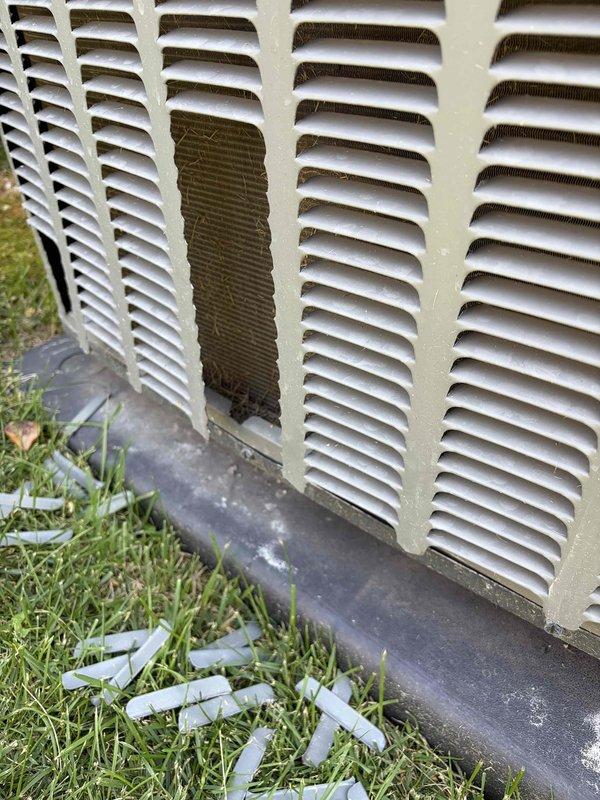 Responded to no cooling complaint on residential AC system of unknown age. Upon inspection, discovered evaporator coil heavily contaminated with thick white crystalline residue buildup, severely restricting airflow and heat transfer capability. Coil condition indicated extended period without maintenance. Exterior condenser unit showed weathering consistent with age and outdoor exposure, with base mounting clips displaced on ground. Documented coil contamination and unit condition with photos. System requires professional coil cleaning or replacement to restore cooling capacity. Recommended establishing regular maintenance schedule to prevent future performance degradation.