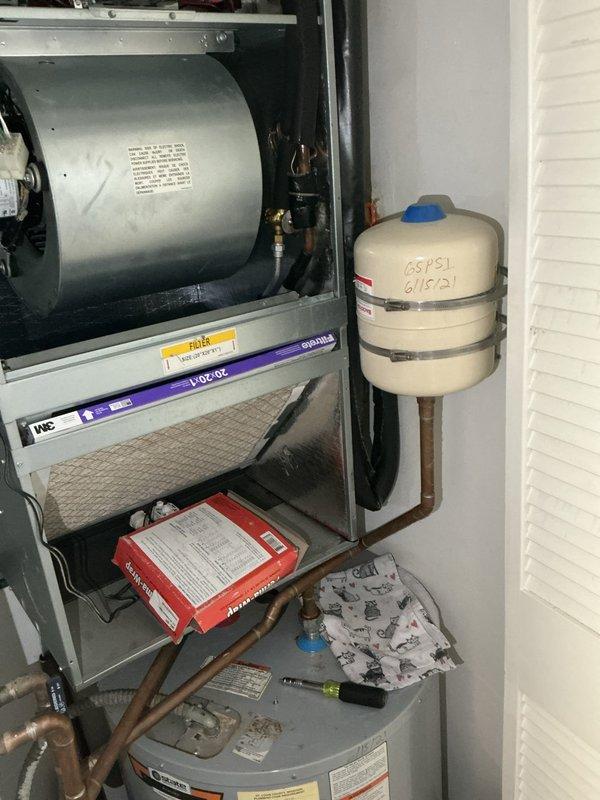 Responded to service call for water leakage from rooftop AC unit dripping onto hot water heater below. Upon inspection, discovered severely deteriorated flexible ductwork insulation with torn sections and fraying around air handler components, along with compromised condensate drainage system. Addressed water leak issue by clearing condensate drain line obstruction and verified proper drainage flow. Documented extensive insulation damage on ductwork and copper refrigerant lines requiring replacement to prevent future moisture issues and maintain system efficiency.