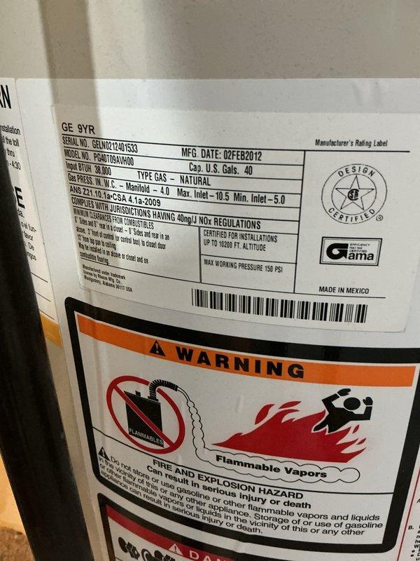 Installed a 40-gallon tall natural gas water heater (GE model 9YR) in basement mechanical room. Unit was properly positioned, connected to existing copper supply lines with insulated piping, vented according to manufacturer specifications, and tested for proper operation. Installation was coordinated with city permit requirements and all safety labels and warnings remain visible and intact per code compliance.