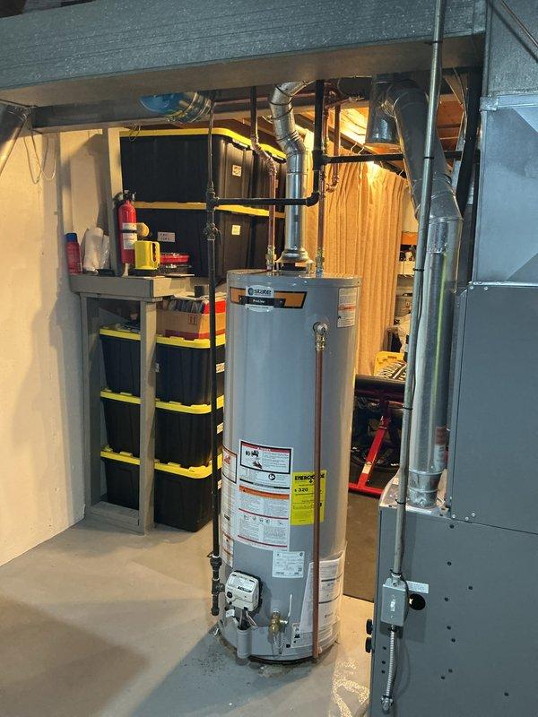Installed a 40-gallon tall natural gas water heater (GE model 9YR) in basement mechanical room. Unit was properly positioned, connected to existing copper supply lines with insulated piping, vented according to manufacturer specifications, and tested for proper operation. Installation was coordinated with city permit requirements and all safety labels and warnings remain visible and intact per code compliance.