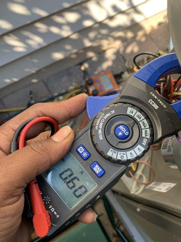 Performed comprehensive cooling system tune-up on 2024 model AC unit located in backyard/side yard area. Conducted electrical diagnostics using clamp meter to verify proper amperage draw and system performance, inspected control panel wiring and capacitor for proper connections and specifications, and documented all components functioning within normal parameters. Customer requested heating system tune-up be scheduled for future service.