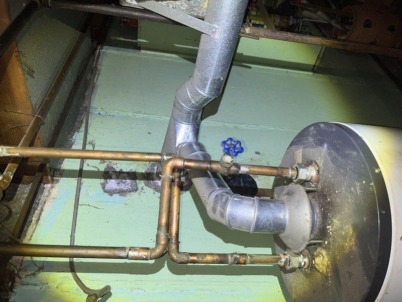 Responded to no cooling complaint on residential air conditioning system. Upon arrival, performed diagnostic evaluation of single unit. Customer had turned off AC and left fan running prior to service call, suspecting capacitor failure. Conducted comprehensive system inspection including visual assessment of mechanical components and utility area infrastructure. Documented existing conditions of plumbing, ductwork, and water heater installation showing age-related wear and corrosion at penetration points. Photographed relevant system components for diagnostic records. Provided diagnosis findings and repair recommendations to customer for approval before proceeding with necessary repairs.