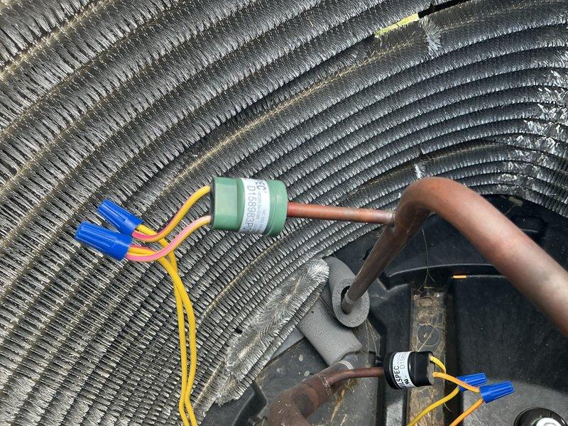 Performed comprehensive second-opinion diagnostic on 2-year-old residential air conditioning system. Conducted thorough inspection of outdoor condensing unit including visual examination of condenser coils, electrical connections, capacitor, and compressor motor assembly. Utilized digital multimeter to test electrical components and verify proper voltage and capacitance readings. Inspected wire connections with twist-on connectors for secure termination and proper polarity. Evaluated condenser coil condition, finding fins clean and free of debris or damage. Assessed compressor motor mounting and electrical connections for integrity. Verified disconnect box and electrical service connections at exterior wall. Provided detailed findings and discussed maintenance membership options with homeowner, noting family member's existing relationship with company.