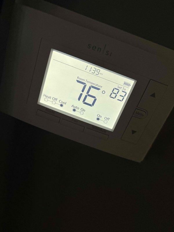 Responded to customer complaint of elevated indoor humidity levels exceeding 60%. Inspected 1-year-old residential HVAC system and verified thermostat operation showing 76°F room temperature with setpoint at 83°F. System confirmed operating in cooling mode with auto fan setting. Evaluated air handler access point and verified proper system cycling. Reviewed thermostat programming and discussed humidity control options with customer to address moisture concerns in conditioned space.