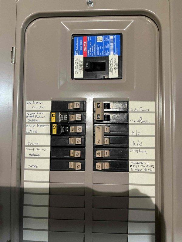 Completed comprehensive electrical system inspection and audit of residential property. Performed thorough examination of main electrical service panel, verifying proper circuit breaker operation, labeling accuracy, and load distribution across all circuits including family room, master bath, dishwasher, guest bedroom, refrigerator/disposal, furnace, sump pump, stove, living room outlets, and smoke detector systems. Inspected attic-level electrical infrastructure, including junction box connections, wire routing through structural framing, and cable management along ceiling joists. Documented existing wiring conditions, noting yellow-jacketed cables, white conductors, and gray service wires properly secured to wooden beams and plywood sheathing. Verified electrical panel interior components, main breaker specifications, and circuit identification systems are functioning as designed with appropriate safety labeling in place.