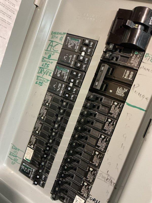 Completed comprehensive electrical home audit including detailed inspection of main electrical panel and safety systems. Documented circuit breaker configuration with existing handwritten circuit labels identifying dormitory master, AC unit, story circuits, parlor, and expansion circuits. Verified alarm system functionality including strobe light and LED indicator panel in utility area. All electrical components and safety devices were photographed for record-keeping purposes and found to be in functional condition with standard wear patterns consistent with regular residential use.