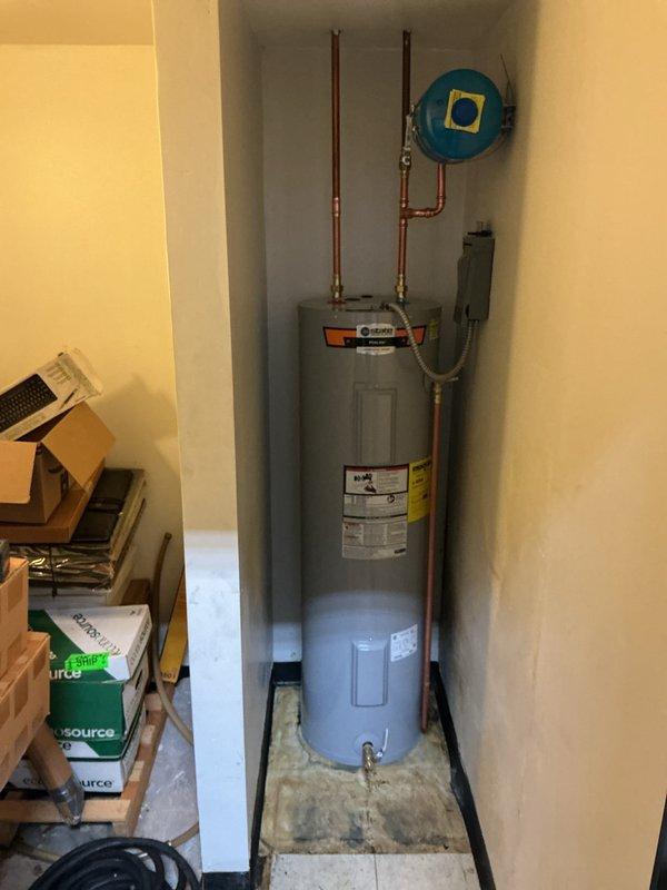 Installed a 40-gallon tall electric storage tank water heater manufactured by State Industries (Ruud brand) in a commercial building utility alcove. Connected copper supply lines, electrical conduit, and verified all plumbing connections per City of Brentwood permit requirements for commercial installation.