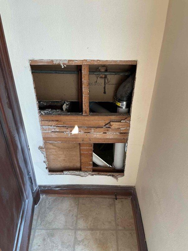 Opened designated wall section within stairwell to provide full access to existing plumbing stack. Removed cast iron piping network from above basement floor level to section above toilet vent in stairwell. Replaced entire system with PVC piping to service one water closet, one lavatory, and one bathtub. Installed and secured new toilet fixture with silicone sealant applied at floor base. Performed water test to verify proper flow and system integrity. Enclosed wall opening, taped and sanded to smooth finish, leaving surface clean and ready for final paint application. Installed two 1" x 8" ceiling boards to restore area where false ceiling was previously located as required by structural layout. All work completed under permit and ready for inspection.