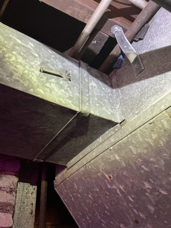 Responded to service call for air conditioning system making noise since April maintenance inspection. Performed diagnostic evaluation of 10-year-old outdoor unit located at side of house. Inspected ductwork system in basement/utility area, examining metal duct connections, joints, and mounting hardware for loose components or vibration points. Checked refrigerant lines, supports, and hangers throughout the system. Identified and addressed noise source, ensuring all ductwork properly secured and system operating quietly. Unit tested and confirmed normal operation upon completion.