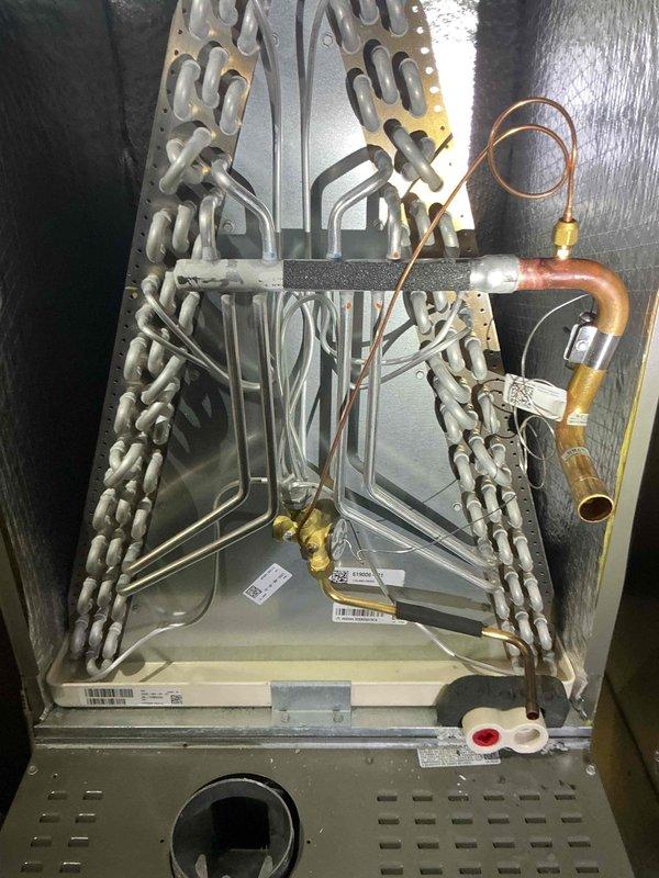 Replaced defective evaporator coil (S/N 1524A59989) under warranty coverage. Removed failed coil assembly, installed new replacement unit, connected refrigerant lines with proper brazing techniques, and verified all connections for leaks. System tested and confirmed operational for both heating and cooling modes upon completion.