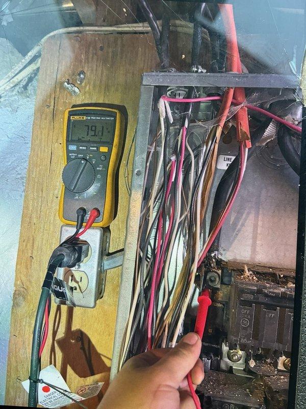 Responded to maintenance callback for AC unit not blowing cold air with inoperative fan. Performed diagnostic testing on electrical panel and control board using Fluke multimeter to measure voltage and continuity. Measured line voltage at 79.1V and additional readings at 1.96V to isolate electrical fault. Inspected wiring connections including line, load, and control circuits within electrical panel. Identified and resolved electrical issue causing fan motor failure. Verified proper voltage supply to all components and confirmed system returned to normal cooling operation with fan functioning correctly.