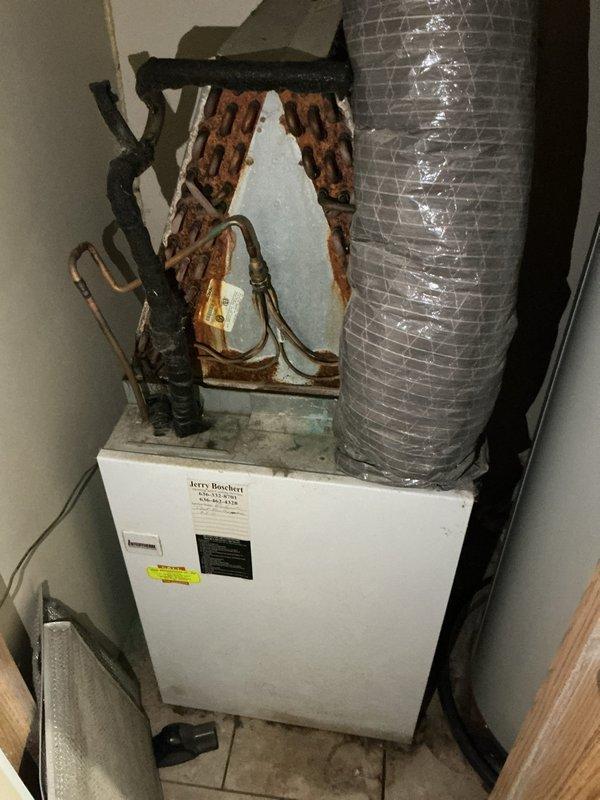Responded to no-cool call with reported smell of smoke from vents and ice formation on refrigerant lines. Upon arrival, found 10+ year old ground-level unit with severely corroded copper refrigerant lines and fittings showing heavy oxidation and deterioration at connection points. Evaporator coil exhibited substantial buildup of dust and debris accumulation, significantly restricting airflow and reducing system efficiency. Ice formation on both indoor and outdoor refrigerant lines confirmed restricted airflow causing coil to freeze. System had been shut down by occupant with fan left running prior to arrival. Documented extensive corrosion damage to refrigerant tubing and connections, as well as heavily contaminated evaporator coil requiring immediate attention. Provided assessment and repair recommendations to restore proper system operation and prevent further damage.