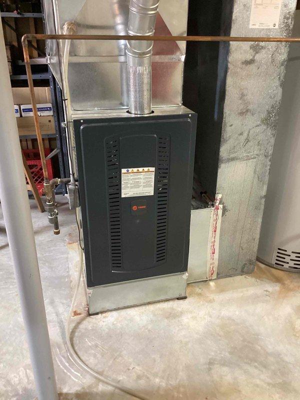Responded to no cooling call on 10+ year old system struggling to maintain temperature. Upon arrival, performed diagnostic testing using refrigerant manifold and micron gauge on outdoor condensing unit. Pressure readings indicated system operating at 901 PSIG on high side and 434 PSIG on low side with subcooling at -770 and superheat measurements showing system imbalance. Inspected indoor furnace/air handler unit in basement and verified airflow operation. System required refrigerant charge adjustment and performance optimization to restore proper cooling capacity.