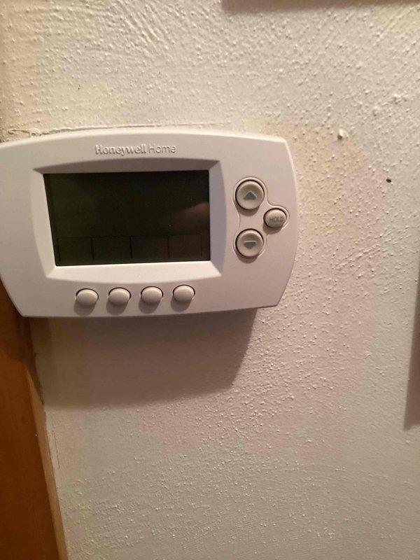 Responded to service call for AC unit freezing over. Upon arrival, inspected the system and found the unit had been turned off per prior instruction. Performed diagnostic evaluation of the electrical control panel and circuit board components. Checked thermostat operation and verified system controls were functioning properly. Documented equipment condition with photos of the control panel wiring and Honeywell thermostat for service records.