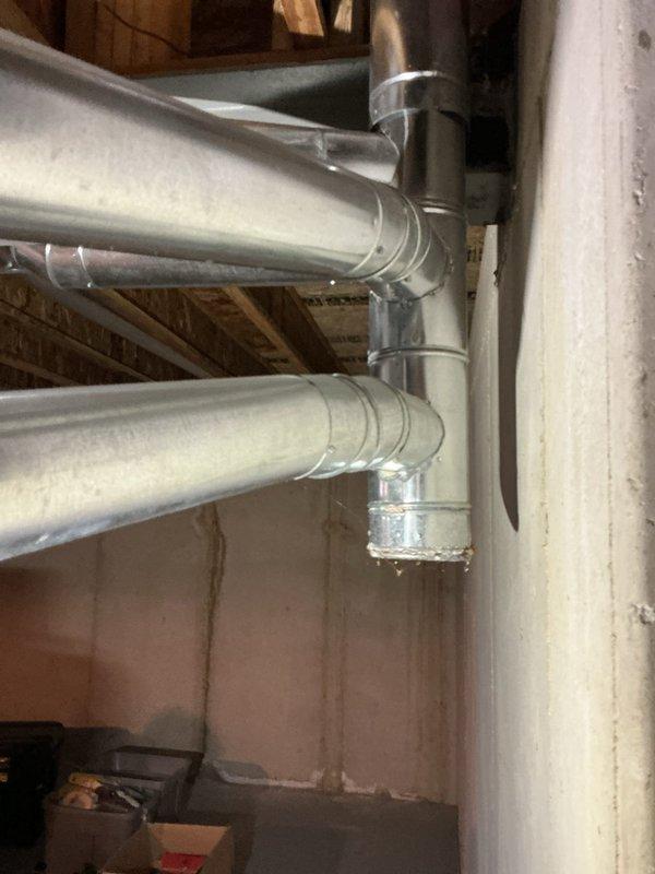 # HVAC Service Completed

Responded to a no cooling call for a two-unit residential system. Upon arrival, found the upstairs unit had been shut down by the homeowner due to evaporator coil freeze-up that occurred the previous night. Inspected both outdoor condensing units located on ground-level pads adjacent to the structure. 

Diagnosed the upstairs system experiencing frozen evaporator coil, likely caused by restricted airflow or low refrigerant charge. Confirmed unit was powered off to allow ice to thaw. Inspected ductwork installation in basement/crawl space area, noting standard galvanized metal trunk lines with proper support and insulation present at wall surfaces.

Evaluated both aging condensing units and discussed system condition with homeowner. Downstairs unit showing signs of age and declining performance, requiring potential replacement in near future. Provided preventive maintenance agreement options to address ongoing system reliability concerns.

Documented equipment 