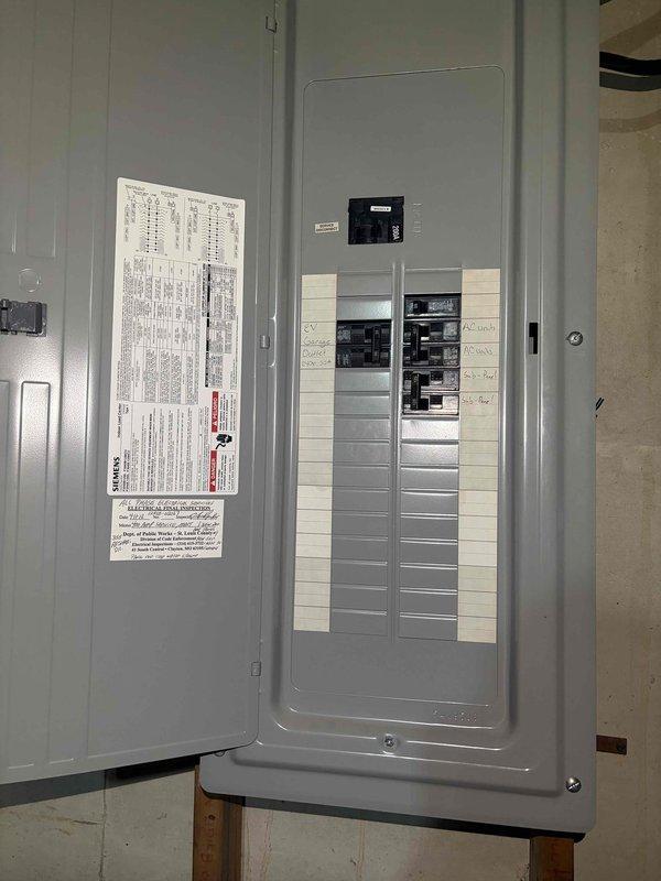 Completed installation of electric vehicle charging station including electrical panel modifications and circuit breaker installation. Mounted charging equipment on interior wall, ran necessary wiring from main service panel, and installed dedicated circuit protection to support the EV charger load requirements per manufacturer specifications and local electrical code.