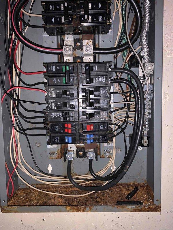 Responded to loss of power affecting main level circuits. Upon inspection, found electrical panel with debris accumulation at bottom and signs of oxidation on bus bar connections. Cleared contamination from panel interior, inspected all breaker connections, and verified proper circuit operation to restore full power to affected areas.