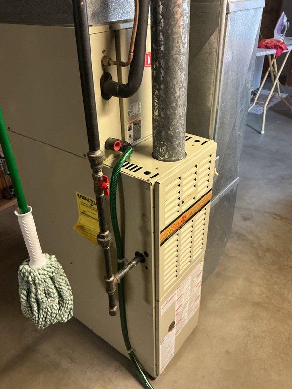Responded to no-cooling call on a thirty-year-old residential air conditioning system. Upon arrival, performed diagnostic evaluation of outdoor condenser unit and indoor furnace system. Confirmed compressor failure on aging cylindrical condenser unit, which showed significant wear consistent with equipment age. Assessed system viability and discussed replacement options with homeowner due to advanced age of equipment and cost-effectiveness of repairs versus new installation.