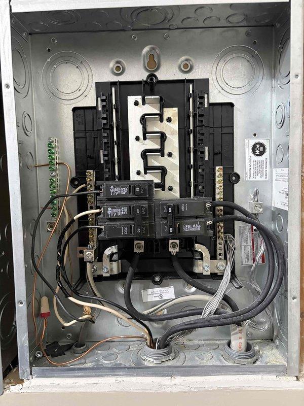 Responded to failed electrical inspection for improper grounding configuration in main service panel. Removed incorrect bonding jumper between neutral and ground bars, then relocated ground wire from neutral bar to dedicated ground bar per NEC requirements. Verified all grounding conductors properly terminated to ground bar and neutral conductors isolated to neutral bar only, ensuring proper separation of grounded and grounding conductors. Panel now complies with code requirements for re-inspection.
