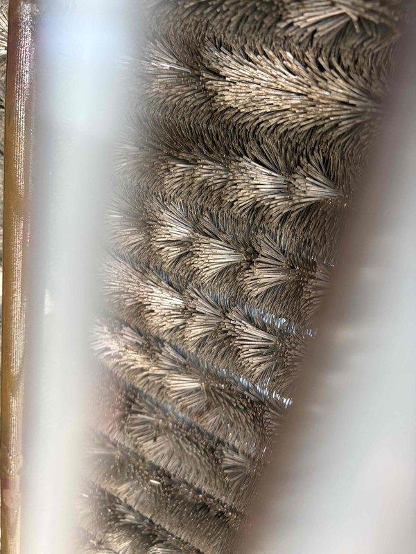 Responded to no cooling call on 15-year-old air conditioning system. Upon inspection, found evaporator coil heavily contaminated with dust and debris accumulation, significantly restricting airflow. Interior components showed extensive soiling with visible mold growth on metal surfaces and drain pan area. Documented system condition with photographs showing herringbone fin pattern coil obstruction and darkened, corroded internal surfaces. Assessed unit requires thorough coil cleaning and system sanitization to restore proper operation and airflow capacity.