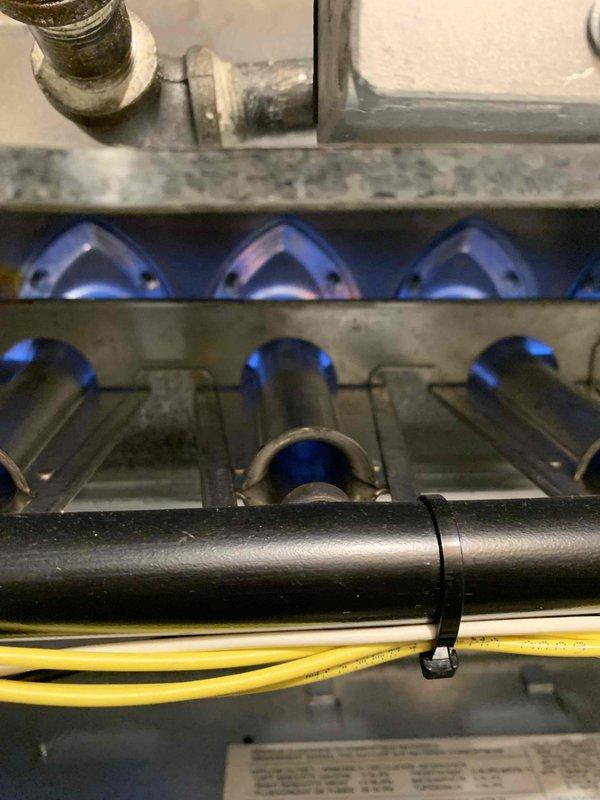 Performed heating maintenance and inspection on residential HVAC system. Conducted thorough examination of gas furnace burner assembly, confirming proper ignition and combustion with clean blue flame pattern across all burners. Inspected heat exchanger and verified safe operation of heating components. Evaluated condensate drainage system in response to previous clogging issue with air conditioning unit, checking for proper flow and addressing concerns about biological growth in drain line. Documented system condition through photographic records showing burner operation and ductwork components.