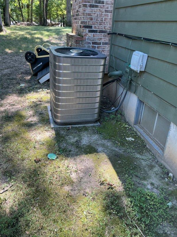 Responded to no-cooling complaint on 10+ year old residential AC unit that had tripped the electrical breaker. Upon arrival, found outdoor condensing unit in side yard location had caused breaker to trip due to electrical overload condition. Inspected circuit breaker panel and confirmed tripped breaker, verified proper breaker sizing for equipment. Examined outdoor unit positioned on concrete pad with conduit and electrical connections along exterior wall. Diagnosed cause of breaker trip and cooling failure, documented equipment condition with photos of both the outdoor unit installation and affected breaker panel. Advised customer to keep system off until repairs could be completed to prevent further electrical issues and potential equipment damage.