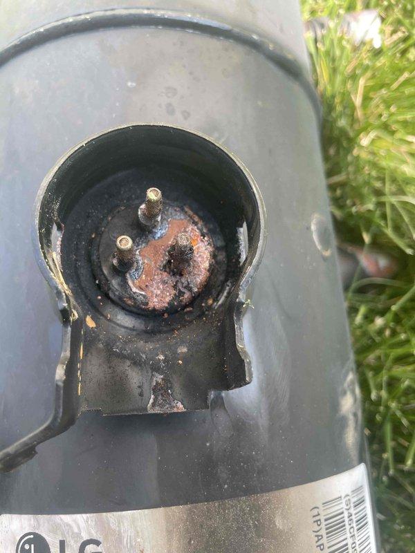 Replaced failed compressor on residential HVAC system that was not providing cooling. Removed old corroded compressor unit showing significant rust and terminal damage, installed new LG replacement compressor (Model APG029KAC, R410A refrigerant, 208-230V). Unit mounted on exterior bracket required two-person lift for safe removal and installation. Documented old and new compressor with photographs per service protocol, retained failed unit for warranty processing.