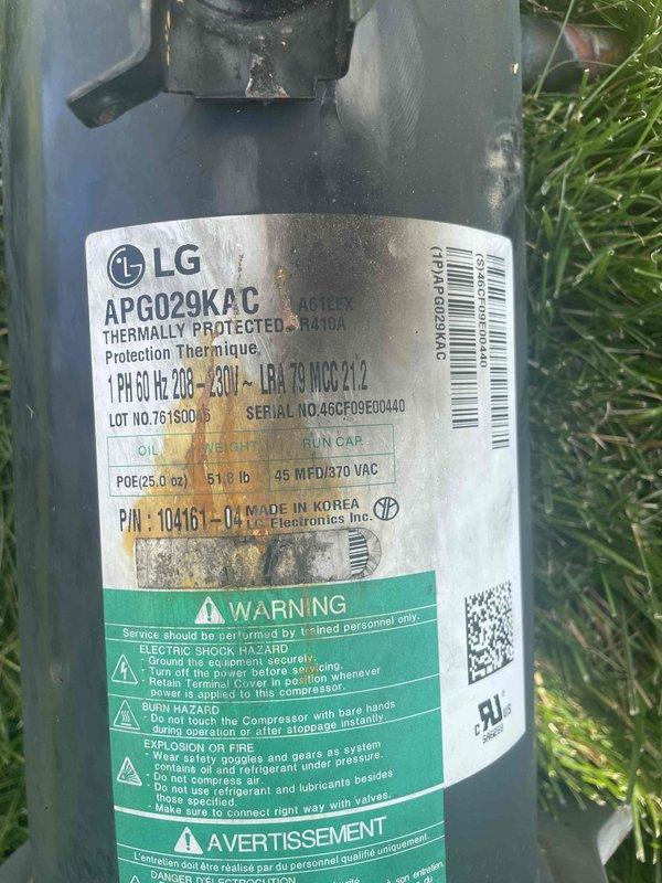 Replaced failed compressor on residential HVAC system that was not providing cooling. Removed old corroded compressor unit showing significant rust and terminal damage, installed new LG replacement compressor (Model APG029KAC, R410A refrigerant, 208-230V). Unit mounted on exterior bracket required two-person lift for safe removal and installation. Documented old and new compressor with photographs per service protocol, retained failed unit for warranty processing.