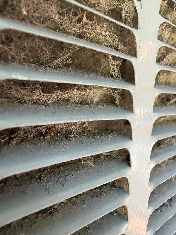 Responded to no cooling complaint on nine-year-old air conditioning unit. Upon inspection, found severely restricted airflow due to heavily clogged evaporator coil and return air grille. Evaporator coil fins were packed with dust, lint, and debris accumulation, significantly reducing heat transfer capability and system efficiency. Return air vent showed extensive buildup of fibrous material, pet hair, and household dust blocking proper air circulation. Cleaned evaporator coil and return air grille, removing all accumulated debris. Restored proper airflow through system, verified adequate cooling operation, and unit returned to normal performance parameters.