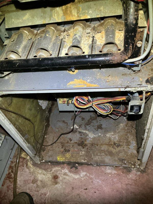 Responded to no cooling call for residential 10-year-old AC system. Upon arrival, provided 30-minute advance notice as requested by customer. Performed diagnostic evaluation of outdoor condensing unit and indoor air handler. Outdoor unit showed normal physical condition with proper placement on concrete pad and functional disconnect box. Indoor unit inspection revealed significant deterioration of heat exchanger components with extensive corrosion, rust accumulation, and yellow staining throughout. Heat exchanger tubes displayed orange-brown rust patches and discoloration indicating advanced age and possible moisture exposure. Interior cabinet showed substantial dirt buildup, rust stains, and greenish-gray deposits on metal surfaces. Wiring bundles and electrical connections were inspected and found intact. Documented conditions with photos for customer review. System age and observed deterioration of critical components noted for discussion of repair versus replacement options.