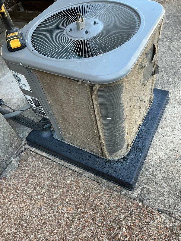 Responded to no cooling complaint on residential air conditioning system located at rear of property. Upon arrival, found outdoor condenser unit with heavy accumulation of dirt, dust, and debris coating exterior panels and coil surfaces, significantly restricting airflow and heat transfer capability. Performed thorough inspection and cleaning of condenser coils and exterior surfaces to restore proper airflow. Unit tested and verified operational following service. System returned to normal cooling operation.