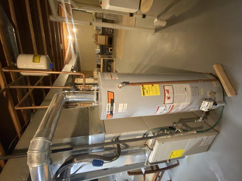 Successfully supplied and installed a new 50-gallon gas tall water heater in the basement, relocating the unit to the backside of the HVAC system as specified. Installed a new 3/4" pressure reducing valve (PRV) above the main water valve on the wide open riser to ensure proper system pressure regulation. Connected all gas lines, water supply lines, and venting according to manufacturer specifications and industry standards. The original service call was initiated due to a pilot light malfunction on the existing water heater, which was replaced with the new unit during this installation. All copper piping connections were properly secured and tested for leaks. The installation was completed without permit requirements as noted in the work order specifications.