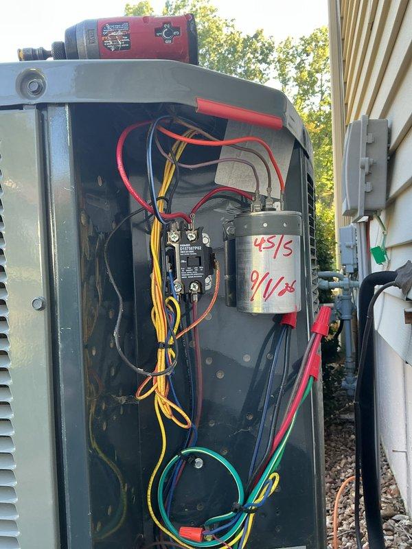 Responded to no cooling complaint on 6-year-old Trane system. Upon arrival, performed diagnostic inspection of outdoor unit and accessed electrical compartment to evaluate capacitor, contactor, and associated wiring connections. Inspected dual-run capacitor marked 45/5 MFD dated 9/1/22, tested electrical components, and verified proper wire terminations on contactor and capacitor terminals. Documented system condition with photos of internal electrical components for service records, completed necessary repairs to restore cooling operation to entire home.