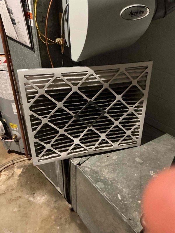 Responded to water leak complaint on residential furnace system located in basement. Upon arrival, performed visual inspection of HVAC unit less than 10 years old. Identified water leakage originating from furnace area. Inspected Aprilaire humidifier component and associated copper piping connections for potential leak sources. Examined air handler unit, condensate drainage system, and surrounding ductwork for moisture accumulation. Documented system conditions with photographic evidence showing air filter assembly, humidifier installation, and copper refrigerant lines. Unable to complete full diagnostic assessment and repair at time of visit. System requires follow-up service to isolate leak source and implement necessary repairs to resolve water discharge issue.