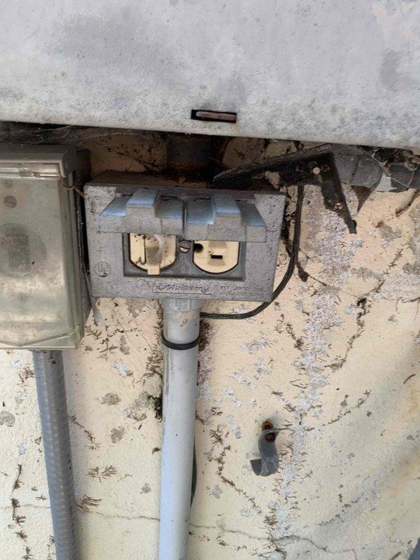 Responded to service call for non-functioning electrical outlets at downstairs pool area. Upon inspection, traced power supply from main electrical panel through exterior-mounted weatherproof outlet box on deteriorated wall surface. Verified proper connections at meter enclosure and tested circuit continuity through white PVC conduit runs. Reset tripped GFCI protection, restored power to all affected outdoor receptacles, and confirmed full functionality of downstairs pool area outlets for customer's electrical tool usage.