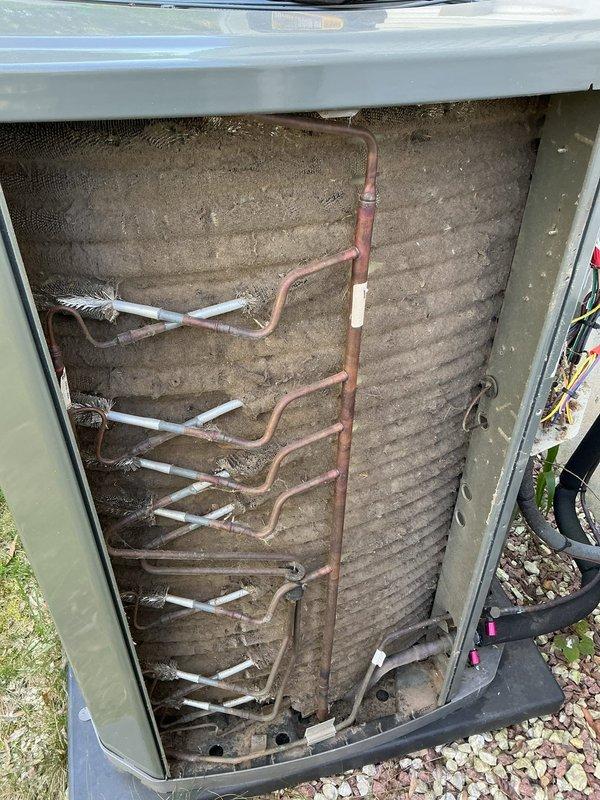 Responded to no cooling complaint on 3-year-old Trane system. Upon inspection, found outdoor unit condenser coil heavily soiled with dirt, dust, and debris accumulation restricting airflow. Removed access panel, inspected electrical components including capacitor, contactor, and wiring connections—all found secure and functioning properly. Cleaned condenser coil to restore proper heat transfer and airflow. Verified refrigerant lines intact with no visible leaks. System tested and confirmed operational with restored cooling capacity.
