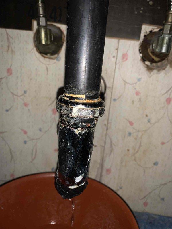 Responded to clogged bathroom sink caused by deteriorated P-trap assembly with visible corrosion at metal coupling and compromised pipe integrity. Removed failed trap section showing extensive mineral buildup and coating degradation, installed new P-trap assembly with proper sealing, and verified drainage flow restoration. Cleared standing water and confirmed all connections leak-free upon completion.
