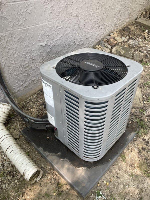 Responded to emergency no-cooling call with indoor temperature at 90 degrees. Upon arrival, found outdoor condenser unit shut off. Performed diagnostic inspection of 10-year-old split system located on side of home. Identified failed electrical connection at condenser control board causing system shutdown. Disconnected and replaced damaged wire connector, secured all low-voltage wiring connections, and restored power to unit. Verified proper operation of condenser fan motor and compressor startup. System cooling normally upon departure with indoor temperature dropping.