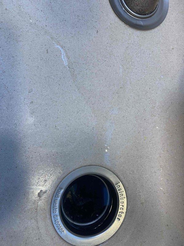 Responded to kitchen sink clog complaint. Two technicians performed cable snaking operation from roof access point to clear drainage obstruction. Successfully restored proper water flow and drainage function to kitchen sink. System tested and verified operational upon completion.