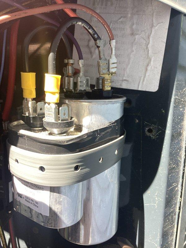Responded to no cooling call on unit 10 located at side of home. Upon arrival, confirmed outdoor fan was not operating and unit had been shut off. Performed diagnostic evaluation and identified failed dual run capacitor preventing compressor and condenser fan motor operation. Replaced defective capacitor with new OEM component, verified proper electrical connections, and tested system operation. Unit restored to full cooling capacity with condenser fan spinning properly and compressor running within normal parameters.