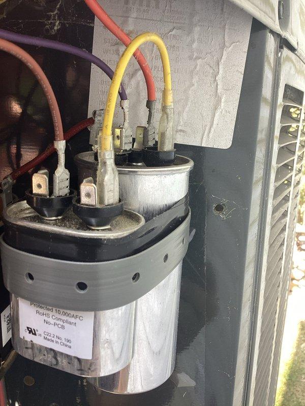 Responded to no cooling call on unit 10 located at side of home. Upon arrival, confirmed outdoor fan was not operating and unit had been shut off. Performed diagnostic evaluation and identified failed dual run capacitor preventing compressor and condenser fan motor operation. Replaced defective capacitor with new OEM component, verified proper electrical connections, and tested system operation. Unit restored to full cooling capacity with condenser fan spinning properly and compressor running within normal parameters.