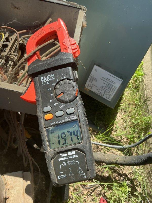 Responded to no cooling complaint on 15-year-old AC system with indoor unit running but outdoor unit not operating. Upon arrival, found outdoor condensing unit not running despite customer's previous breaker reset attempt. Performed diagnostic testing and measured amperage draw at 19.14 amps using digital clamp meter. Inspected outdoor coil and found significant dirt, debris, and possible mold accumulation on condenser fins, along with rust streaks on housing indicating extended environmental exposure and lack of maintenance. Outdoor unit failure attributed to compromised airflow from heavily soiled coil and potential electrical or mechanical component failure requiring further evaluation.