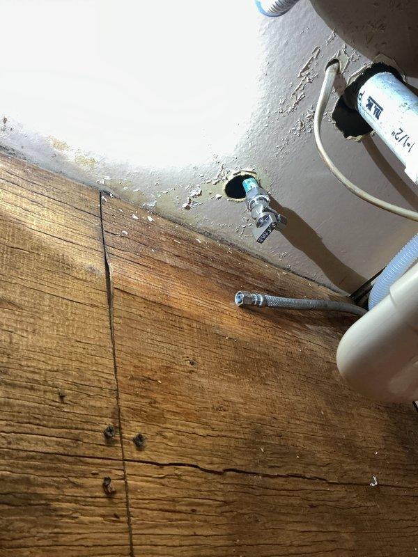 Installed a new 40-gallon electric water heater (47" x 20") in vacant apartment unit. Supplied and installed new 3/4" pressure reducing valve and main shut-off valve, then ran 3/4" copper piping from the water heater to the first hot water tee. Replaced powder room lavatory drain components including new PVC 45-degree elbow and P-trap assembly. Per customer request, kitchen sink water supply line was intentionally left disconnected as unit is undergoing remodeling.