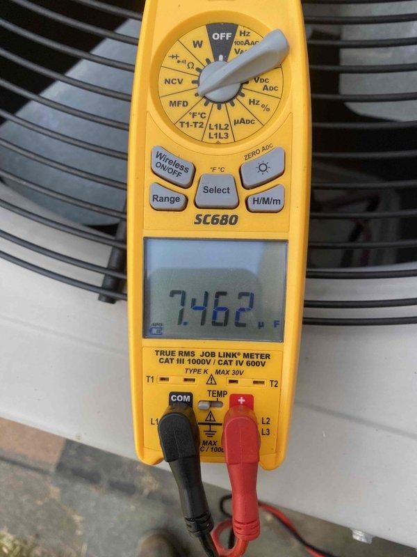 # HVAC Service Completed

Responded to a no cooling complaint affecting the entire home with a 13-year-old air conditioning system. Upon arrival, performed visual inspection of the outdoor condensing unit and identified severely restricted airflow due to heavily clogged condenser coil fins. The coil surfaces showed significant accumulation of dirt, dust, and debris throughout, causing brownish discoloration and blocking proper heat transfer.

Cleaned the condenser coil thoroughly to restore airflow through the fins and remove all accumulated contaminants. Following the cleaning, performed electrical diagnostics using a digital multimeter to verify system operation. Measured and recorded capacitor readings, confirming proper electrical component function with a reading of 2462 microfarads displayed on the meter.

Cycled the system and verified proper cooling operation was restored. The unit is now operating within normal parameters with adequate airflow across the condenser coil. Advise