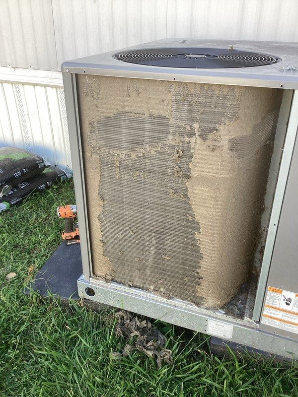 Responded to service call for air conditioning unit experiencing short cycling with fan operational. Upon inspection, found condenser coils heavily contaminated with dirt, dust, and debris causing restricted airflow and system inefficiency. Removed side access panel and documented extensive buildup on condenser fins and coils. Performed diagnostic testing using refrigerant manifold gauge to verify system pressures and temperatures. The severe contamination was identified as the primary cause of the cycling issue, as restricted airflow prevented proper heat exchange and triggered high-pressure safety cutoffs.