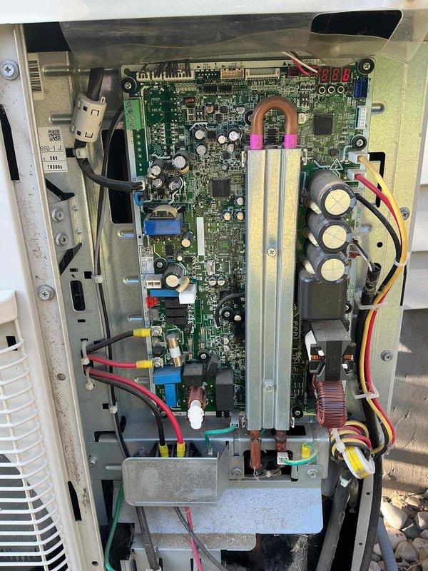 Responded to no cooling complaint on Unit 10 located at ground level. Customer reported outdoor unit making struggling sounds and failing to produce cold air. Upon inspection, accessed and photographed control board assembly revealing signs of component stress and potential electrical issues within the PCB system. Identified corrosion present on mounting chassis near circuit board connections. Documented complex wiring configuration including multiple capacitors, integrated circuits, and terminal connections for diagnostic purposes. Per customer instructions, system was shut down with fan left in operational mode to prevent further component damage pending repair authorization.